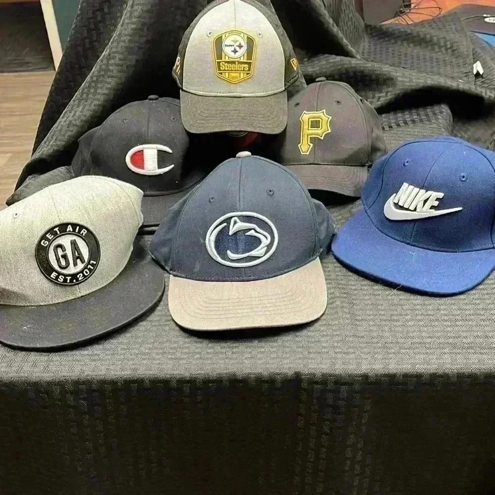 Six ball caps. Some never worn. Some gently used.